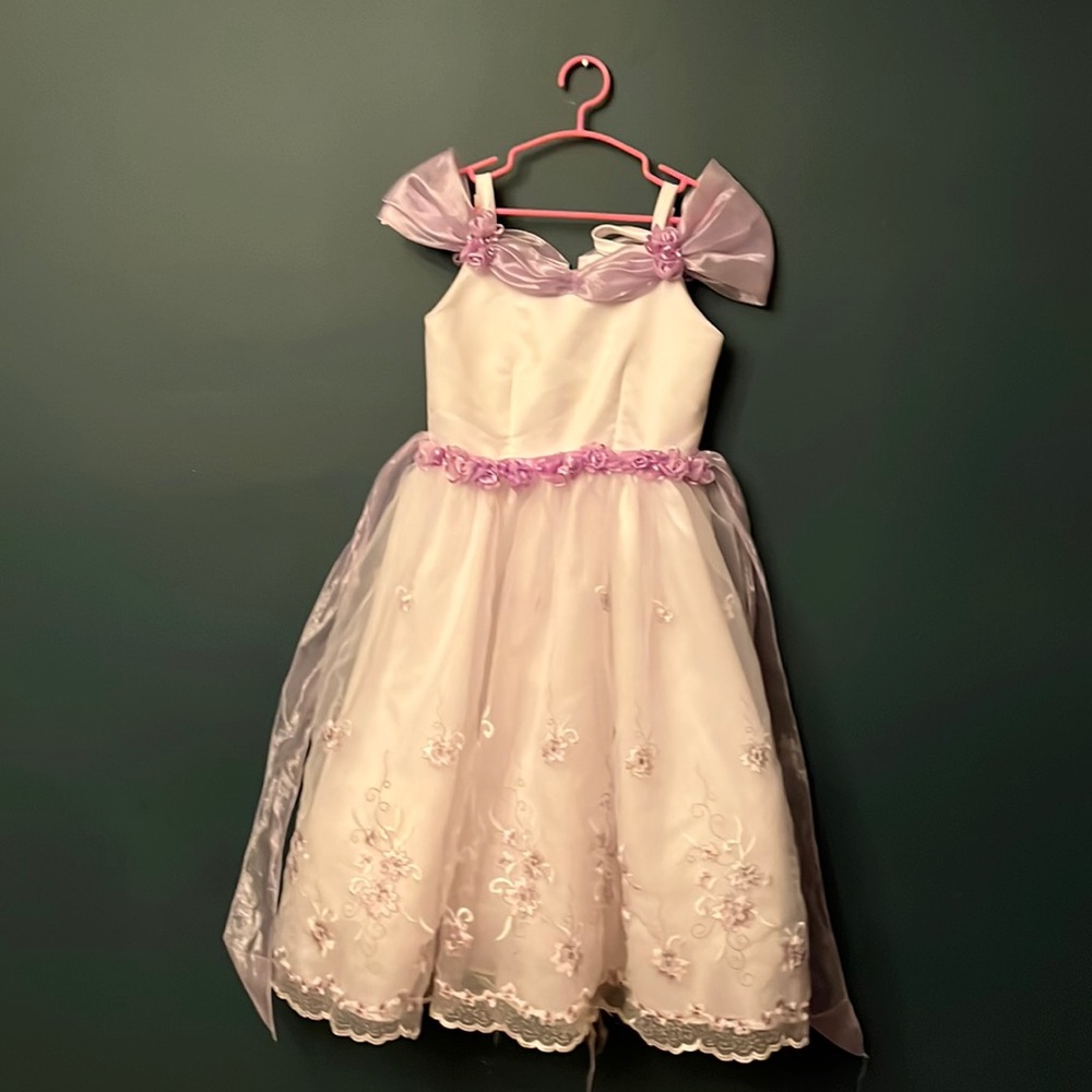 Beautiful white flower girl dress with lilac flowers.